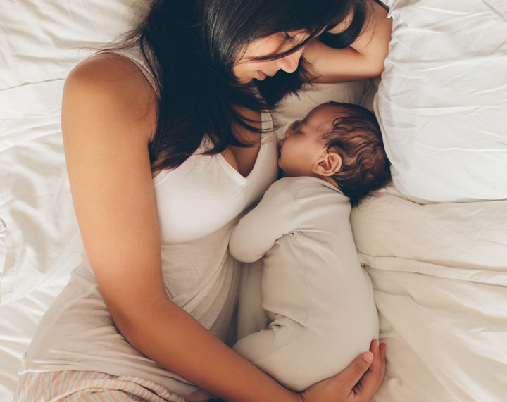 Mother hugging her newborn baby