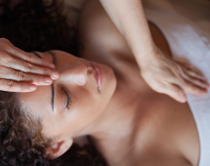 Image of a woman receiving energy treatment